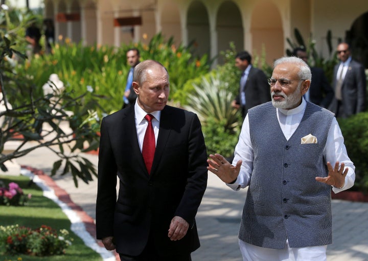 Russian President Vladimir Putin (L) and India's Prime Minister Narendra Modi walk during their meeting in Benaulim, in the w