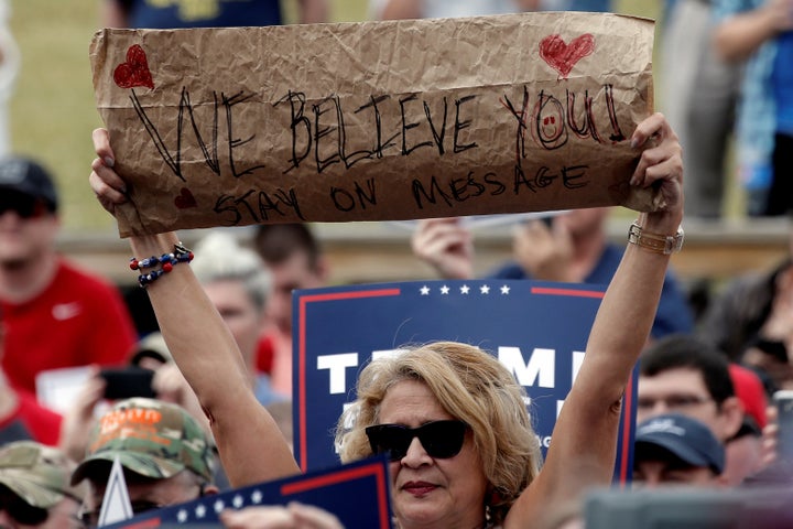 A supporter of Republican U.S. presidential nominee Donald Trump holds a sign at a campaign rally in Greensboro, North Caroli