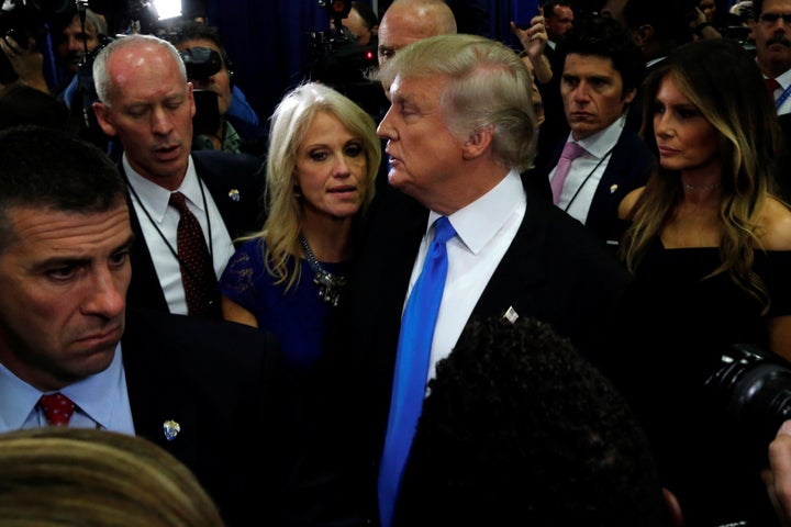 Republican U.S. presidential nominee Donald Trump talks to campaign manager Kellyanne Conway in the spin room after his first