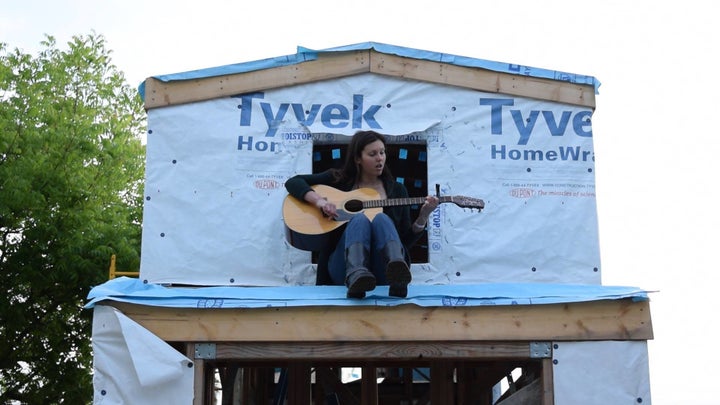 Malinda Crichton perches in the loft of the tiny home she is building. 