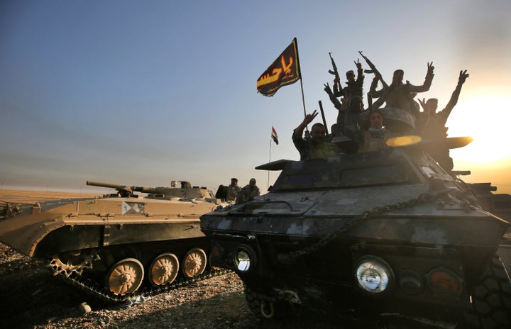 Iraqi forces deploy in the area of Al Shourah, about 27 kilometers south of Mosul, as they advance toward the city to retake