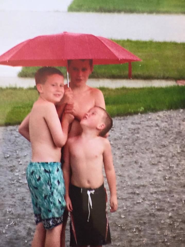 {Photo of my three boys playing in the rain. I was taking the perfect photo and I was not in the rain with them. I should have been!}