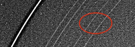 The alpha and beta rings, circled in this 1986 image taken by Voyager, could be hiding two very small moons. 