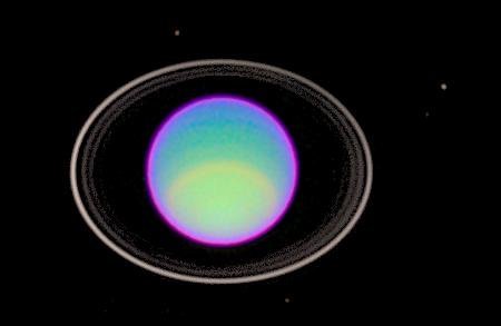 Uranus and its rings seen in a false-color image taken by the Hubble Space Telescope in 1995. The rings are normally ver