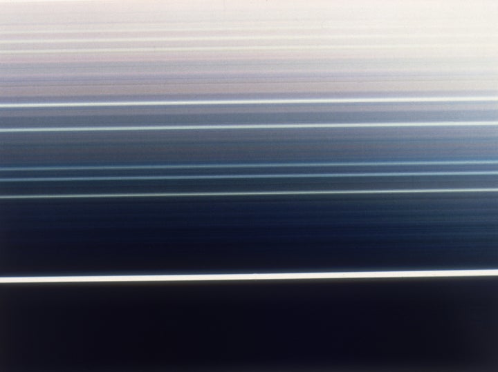 A false-color image taken by Voyager shows the rings of Uranus. Astronomers believe they've found evidence of two previously unknown moons hidden in the rings.