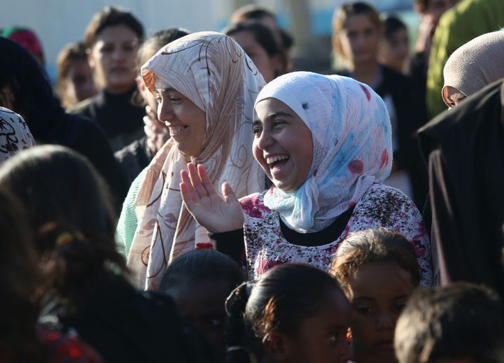 Yazidi refugees celebrate news of the liberation of their homeland, Sinjar, at a refugee camp in the Rojava region of Syria on Nov. 13, 2015.