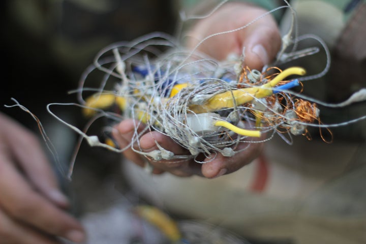 A Kurdish Peshmerga fighter holds the remnants of an ISIS-made improvised explosive device after dismantling it in Hasan al Sham, a village between Erbil and Mosul, in October.