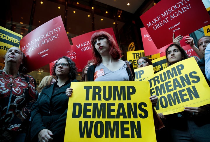 Activists rally during a protest against Trump on Monday. Multiple women have come forward recently alleging sexual misconduct against Trump. Trump has denied all allegations.