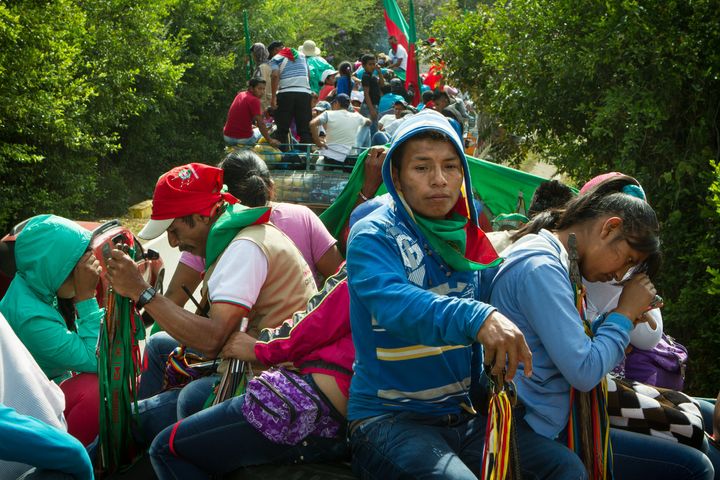 Thousands of people pile onto the tops of busses for a caravan procession to demonstrate he indigenous movement's support of the peace process.