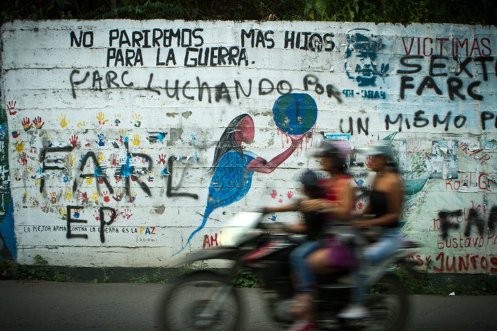 A mural outside of Toribio Cauca reads, "We will not give birth to more children for the war." Below that pronouncement, FARC graffiti illustrates enduring turf wars.