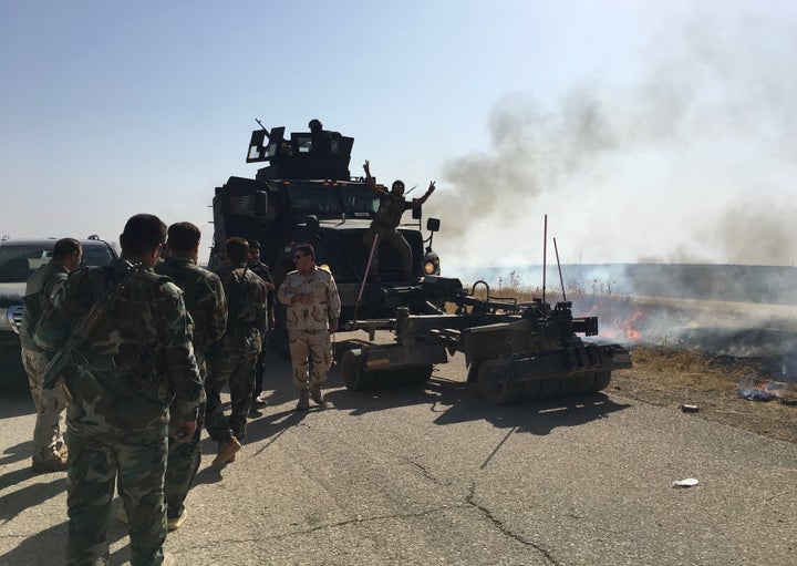 Iraqi soldiers man a minesweeper vehicle in Hasan al Sham, northern Iraq, on Tuesday.