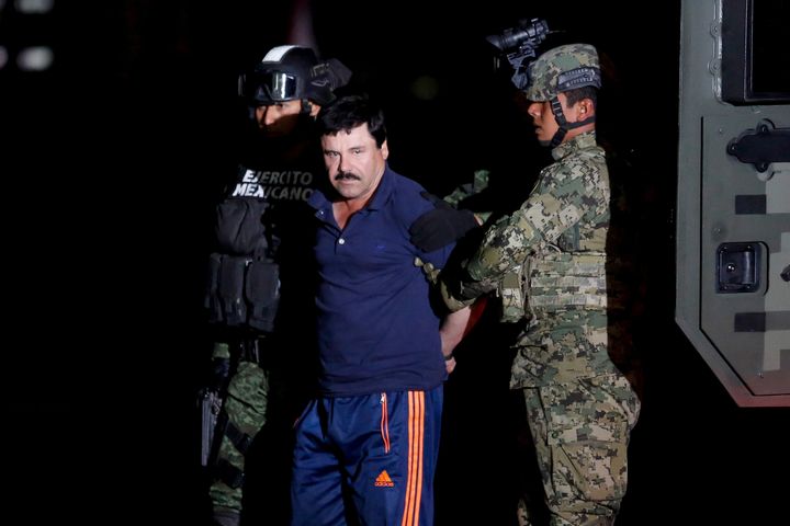 Joaquin "El Chapo" Guzman is escorted by soldiers during a presentation in Mexico City, January 8, 2016.
