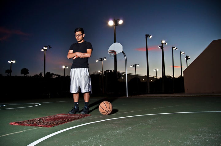 A young man prays on a basketball court in Florida.