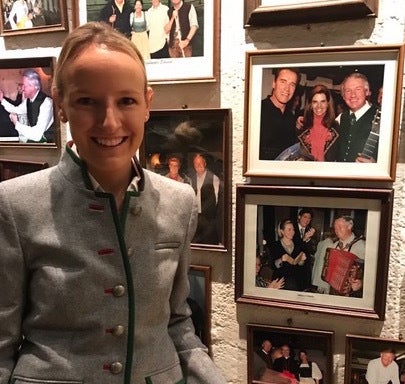 Maria Hauser next to photo of her father and Hillary circa 1997