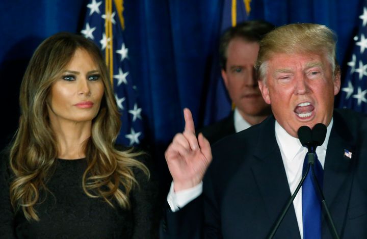 Republican U.S. presidential candidate Donald Trump gestures during his victory speech as his wife Melania, looks on at his 2016 New Hampshire presidential primary night rally in Manchester, New Hampshire February 9, 2016.