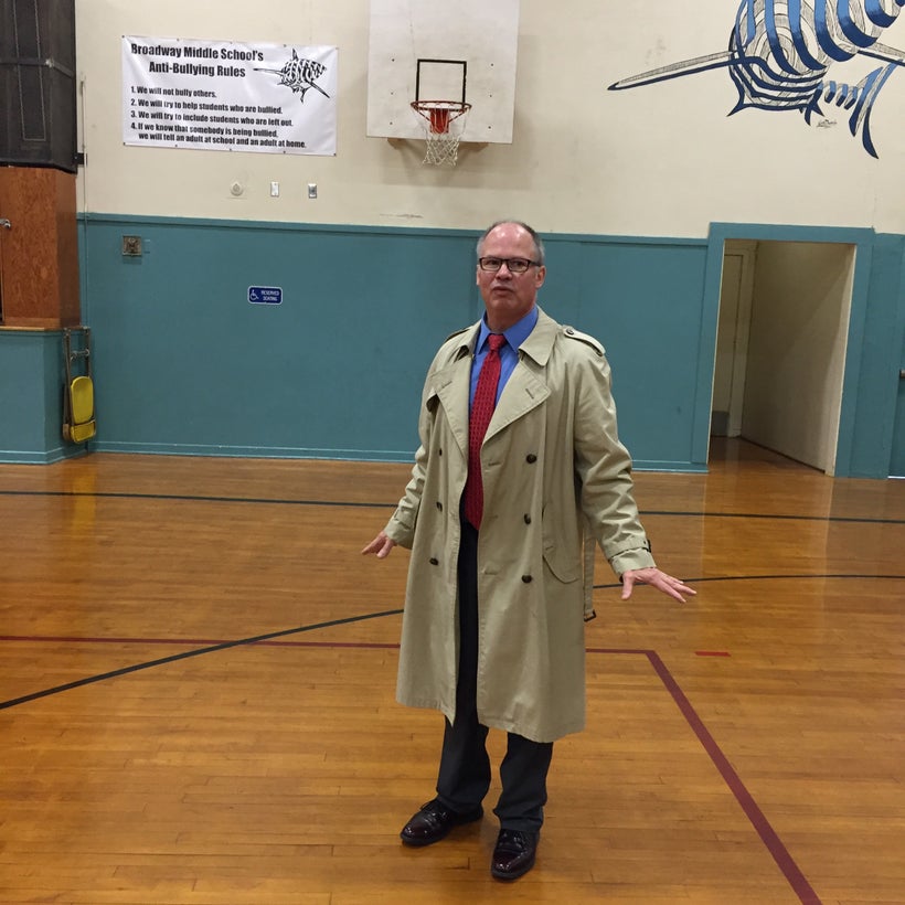 Seaside Superintendent-emeritus Doug Dougherty leads a tour of Seaside's schools. In the high-school gym, metal roof tie-down