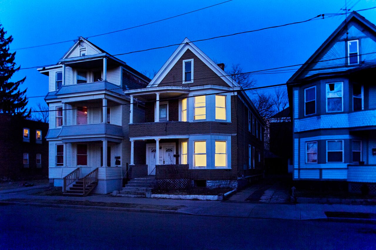 Houses lit up at night for the "Breathing Lights" exhibition.