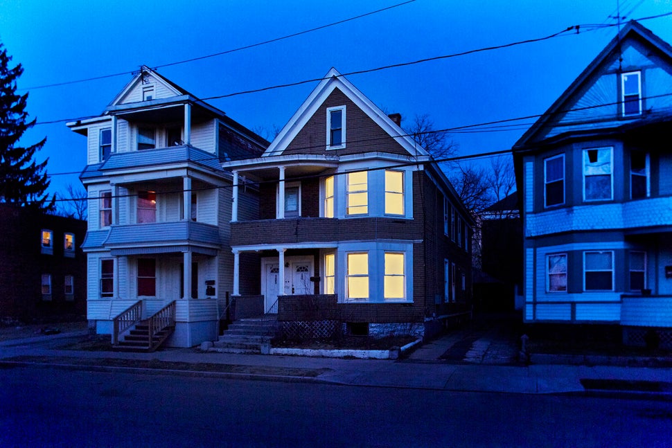 Houses lit up at night for the "Breathing Lights" exhibition.