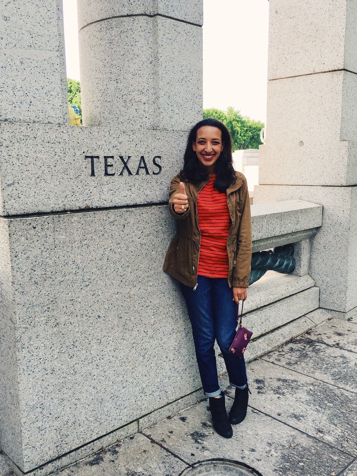 Isis poses in front of the Texas monument at the National World War II memorial in Washington D.C., while holding up the "gig