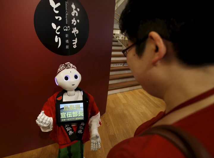 SoftBank's human-like robot named 'Pepper' speaks to a customer in its role as a PR manager at a speciality store in Tokyo, Japan, July 1, 2015.