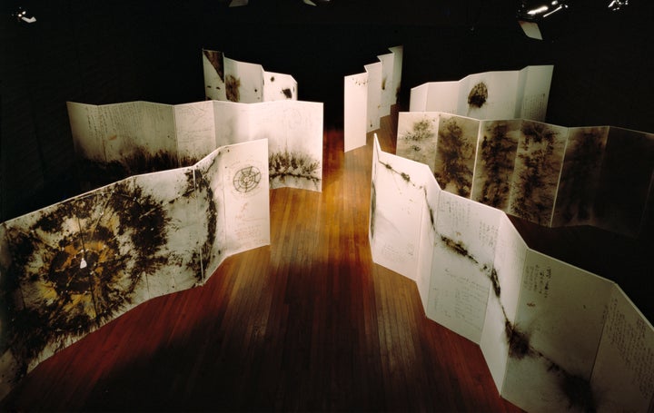 Seven of Cai's gunpowder drawings on paper mounted on board as folding screens, titled Primeval Fireball: The Project for Projects, 1991, at P3 art and environment, Tokyo.