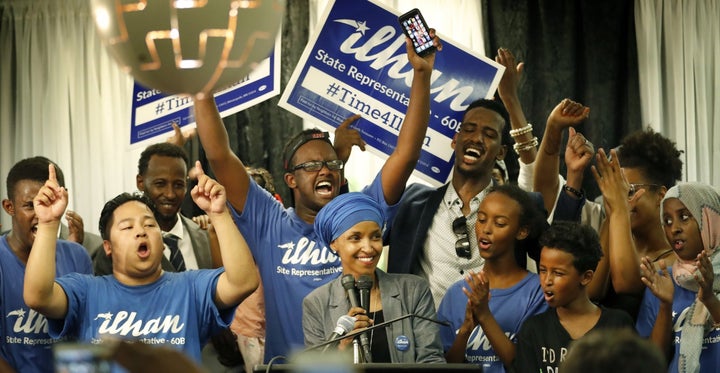 Ilhan Omar celebrates with supporters after her state's primary elections.