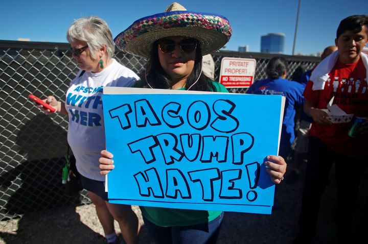 A protestor holds a sign at the Wall of Tacos demonstration in front of the Trump International Hotel Las Vegas on Wednesday.