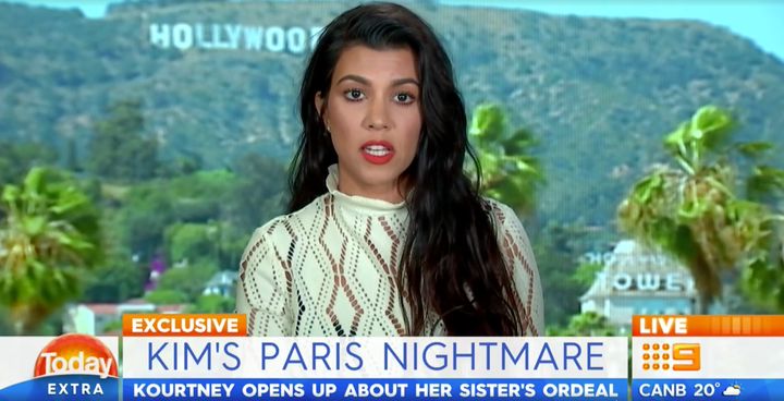 <strong>Kourtney stares ahead while being addressed by a PR</strong>