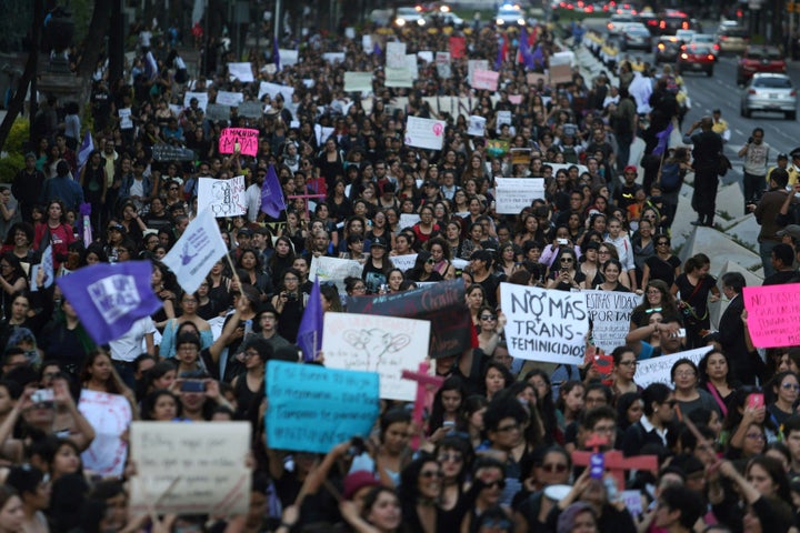 Activists take part in a march to protest violence against women and the murder of a 16-year-old girl in Argentina last