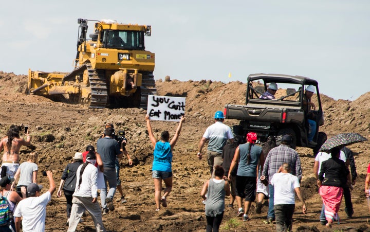 Native American protestors and their supporters are confronted by security during a demonstration against work being done for the Dakota Access Pipeline (DAPL) oil pipeline, near Cannon Ball, North Dakota, September 3, 2016.