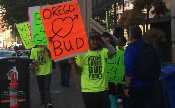 Here are some people in Portland who were paid to carry signs for Bud Pierce, Oregon's GOP candidate for governor. The man in the front threatened a knuckle sandwich if his picture was taken.