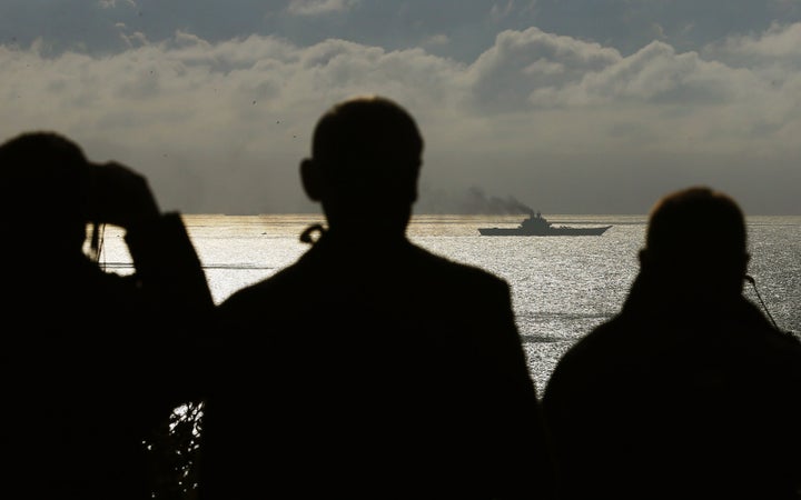 Observers regard the carrier from Dover 