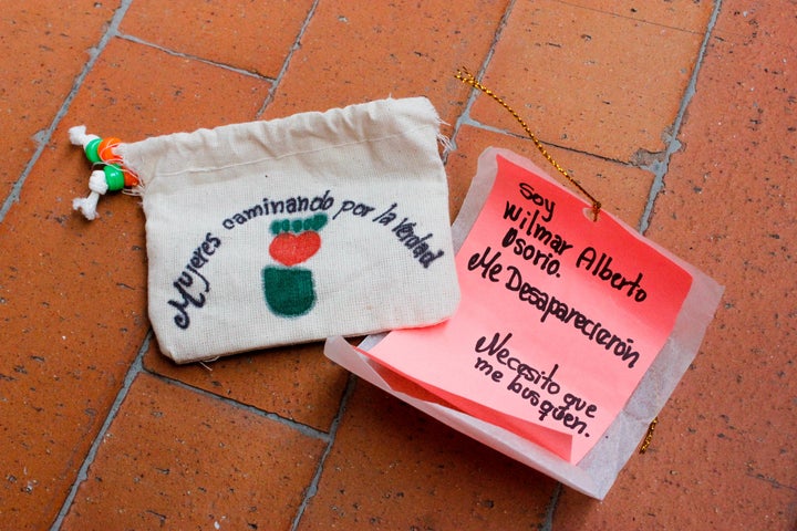 Women Wallking for Truth member Luz Elena Galeano Laverde hand made pouches containing "notes from the disappeared" for distribution at an event commemorating Operation Orion. This note reads: "I am Wilmar Alberto Osorio. They disappeared me. I need you to find me."