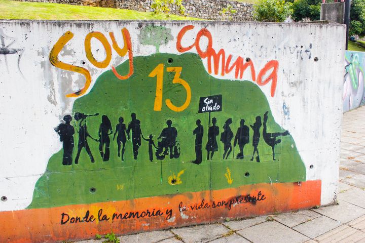 A mural painted near the San Javier Library reads: "I am Comuna 13, where memory and life are present."