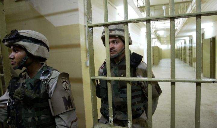 U.S. soldiers guard cells inside the prison of Abu Ghraib, outside Baghdad, Iraq, on May 5, 2004.