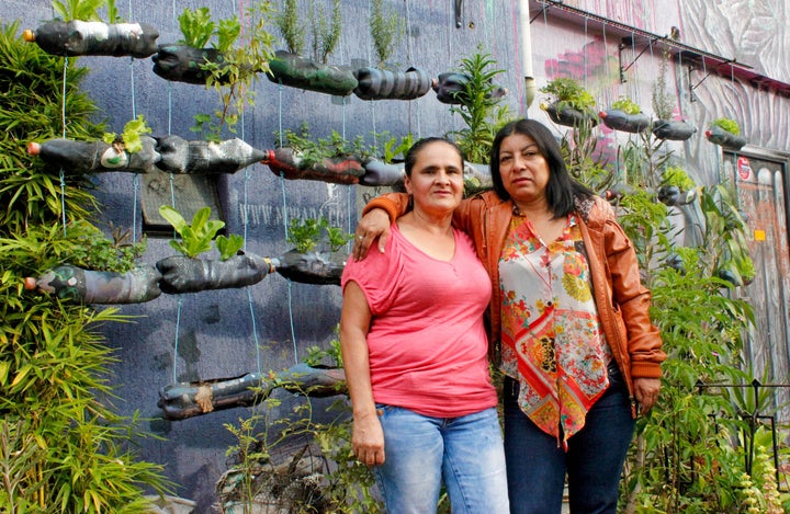 Women Walking for Truth members Blanca Nidia Perez Botero (right) and Luz Elena Galeano Laverde (left) outside of "La Casa Morada," an activist meeting space in the Comuna 13 neighborhood of Medellín.