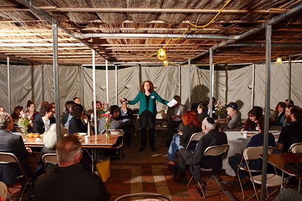 Rabbi Barbara Penzner addresses Jewish Labor Committee Dinner in the Harvard Hillel Sukkah on behalf of striking HUDS workers