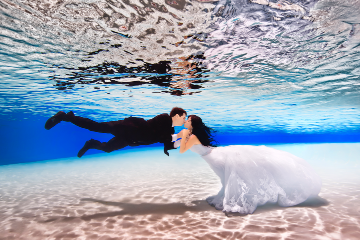 "For me, it's just the weirdest thing having shoes and socks on and a suit in the pool," the groom said.