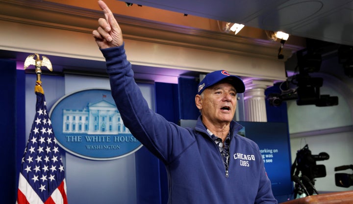 Wearing Chicago Cubs attire, actor Bill Murray takes to the lectern in the briefing room during a visit to the White House on