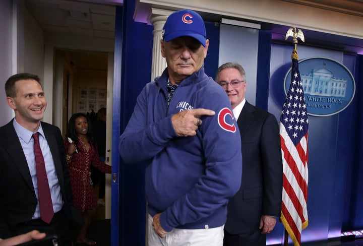 Murray, center, gestures as he visits the James Brady Press Briefing Room.