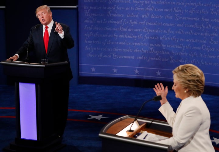Republican U.S. presidential nominee Donald Trump speaks as Democratic U.S. presidential nominee Hillary Clinton listens duri