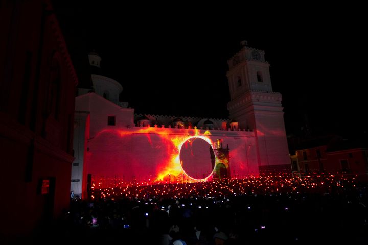 Pedestrians gather for ah exhibition lighting a Catholic church in Quito during the Habitat III conference on Oct. 18.
