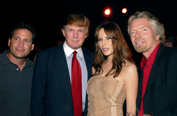 (L-R) Virgin Mobile USA CEO Dan Schulman, Donald Trump, Melania Trump and Sir Richard Branson at the Whitespace Studio on July 24, 2002.