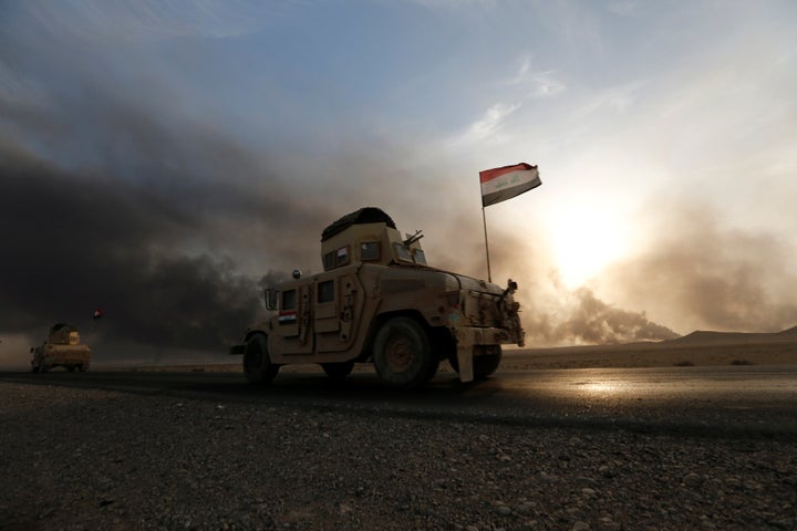 Iraqi army gather after the liberation of a village from Islamic State militants, south of Mosul, during an operation to attack Islamic State militants in Mosul, Iraq, October 21, 2016.