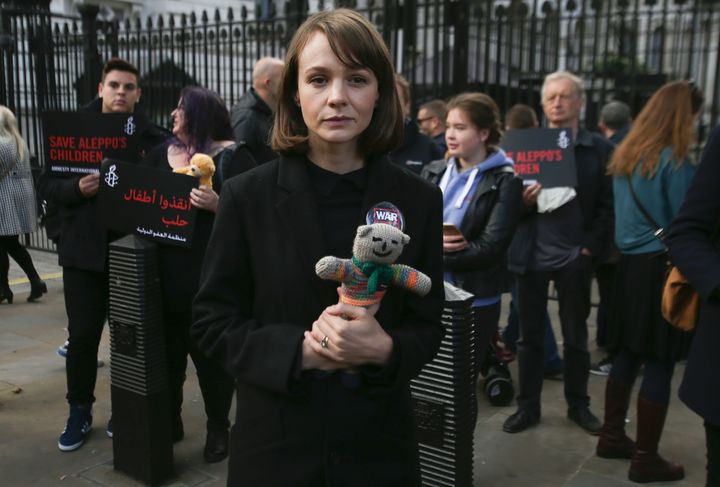 British actress Carey Mulligan holds a teddy bear as she joins demonstrators in a rally calling on the government to take action to protect the children of Aleppo.