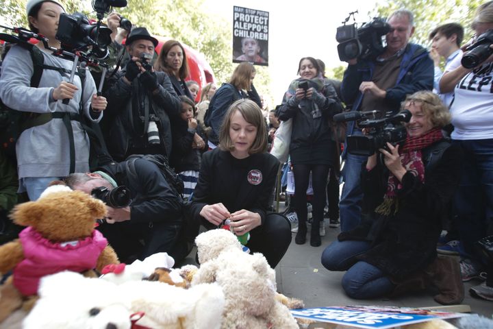 Carey Mulligan (C) is surrounded by media as she joins demonstrators and places a teddy bear outside Downing Street.