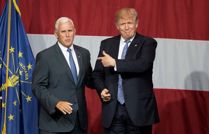 Republican presidential nominee Donald Trump (R) and Indiana Governor Mike Pence (L) take the stage during a campaign rally at Grant Park Event Center in Westfield, Indiana in July.