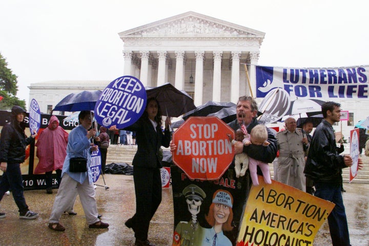 Pro-choice and anti-abortion activists demonstrate in front of the Supreme Court building as arguments on Nebraska's partial birth abortion law are heard before the court. 