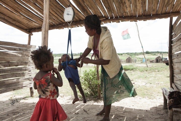 A woman checks the weight of her baby at a health center in southern Madagascar on March 4, 2015.