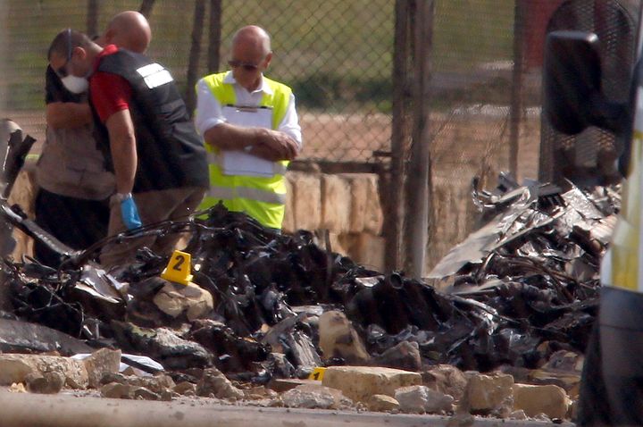 Investigators and rescue services at the scene of a plane crash at the airport on Monday